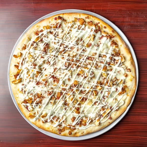 A whole Big Joe's Pizzeria chicken bacon ranch pizza with white sauce drizzle on a wooden table.