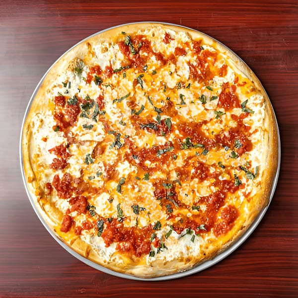 Big Joe's Pizzeria's white pizza with dollops of red sauce and fresh basil on a wooden table.